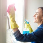 attractive-smiling-woman-washing-window-with-spray-rag_283617-8893.jpg