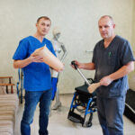 two-prosthetist-man-workers-with-prosthetic-leg-working-laboratory.jpg