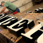 Fabricator-Assembling-Channel-Letters-in-a-sign-shop.jpg