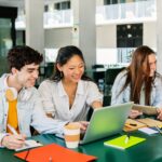 happy-young-group-of-multiracial-students-working-together-on-laptop-at-college-1024x1536.jpg