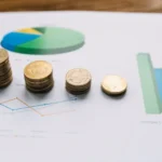 close-up-stacked-coins-graph-chart.webp