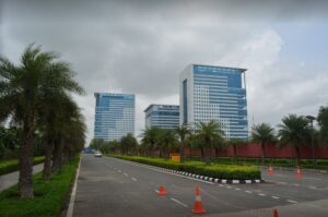 Exterior view of DLF Corporate Greens Tower 1 in Sector 74A, Gurgaon, featuring modern architecture and corporate office entry.
