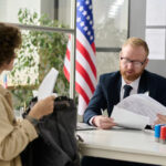 portrait-male-worker-revising-documents-young-woman-applying-visa-us-immigration-office_622301-5672.jpg