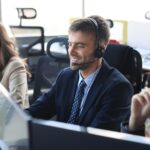 portrait-call-center-worker-accompanied-by-his-team-smiling-customer-support-operator-work.jpg