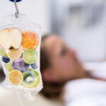 A-blurred-image-of-a-woman-taking-IV-Drip-Vitamin-Infuser-Therapy-Solution.jpg