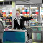 airline-check-attendant-showing-direction-commuter-check-counter-1-1.jpg