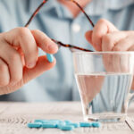 man_holding_blue_pill_813713476.jpg