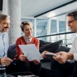 happy-couple-financial-advisor-going-through-plans-meeting.jpg