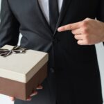 unrecognizable-businessman-holding-brown-gift-box_1262-18123.jpg