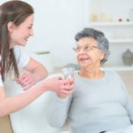 Caregiver-Giving-Water-to-Elderly-Woman-2-1024x683.jpg