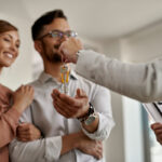 closeup-real-estate-agent-giving-couple-keys-their-new-home.jpg