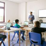 confident-teacher-explaining-lesson-pupils-1.jpg