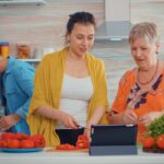 mother-daughter-cutting-pepper-looking-tablet-cooking-using-online-digital-tablet-recipe-pc-computer-home-kitchen-while-preparing-meal-extended-family-cozy-relaxing-weekend-1-1-1.jpg