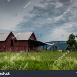stock-photo-pine-bush-ny-usa-june-red-barn-and-grass-field-under-a-stormy-sky-with-shawangunk-1168458256.jpg
