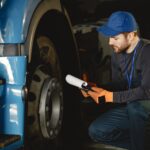 young-worker-checks-wheel-truck-malfunction-service-work-1-1-1.jpg