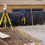 a-theodolite-on-use-on-a-partially-cast-concrete-slab-in-a-construction-site.jpg