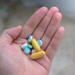 many-pills-and-colors-on-hand-top-view-and-close-up-in-blurred-background-for-concept-of-medicine-for-treating-disease-or-nourishing-the-body-photo.jpg